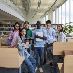 full-shot-smiley-students-library